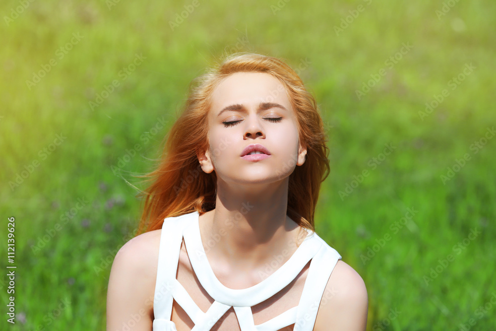 Young beautiful woman on green grass background Young beautiful woman on green grass background