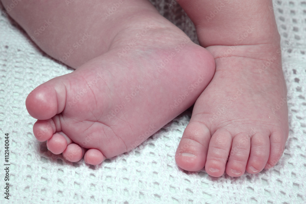 Newborn child cute feet on blanket Newborn child cute feet on blanket