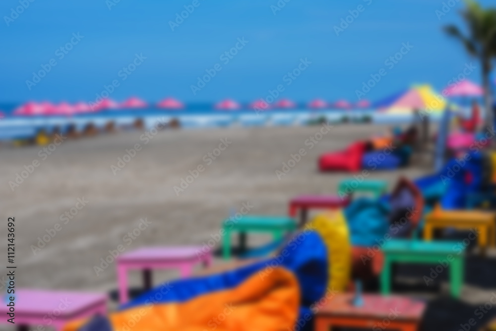 empty cushioned chairs and loungers on the beach