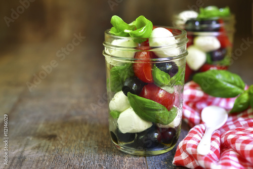 Fotografie Caprese salad in a mason jar.