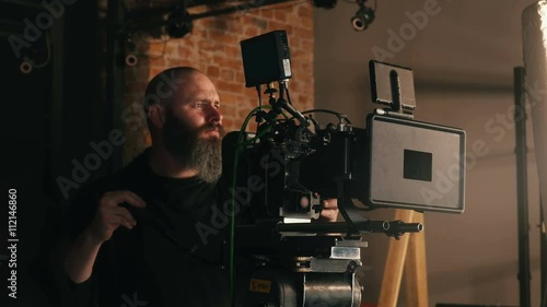Professional film shoot in studio with operator on fully rigged camera