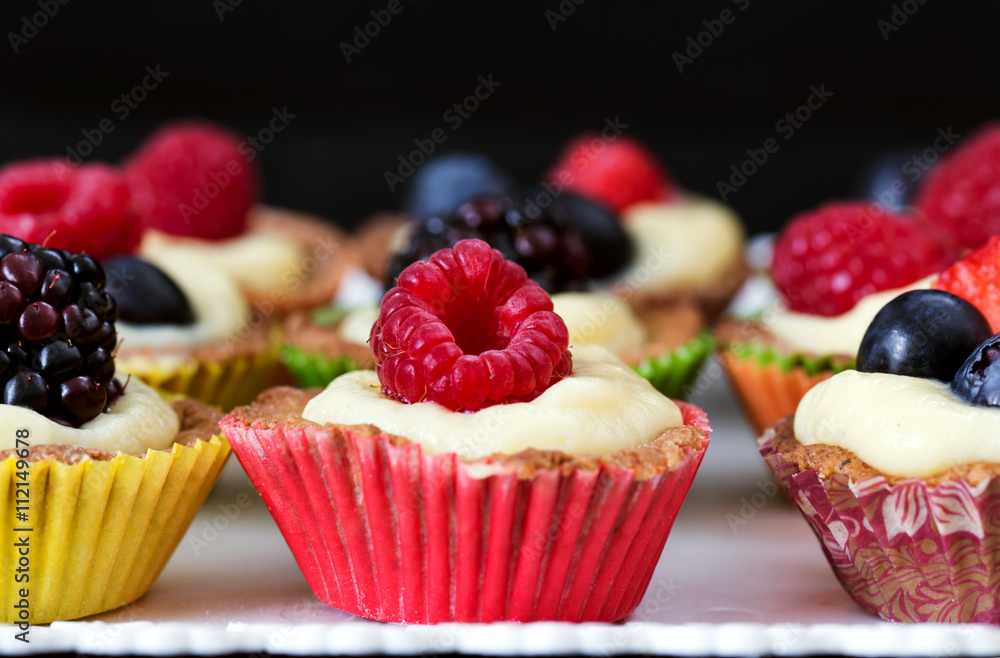 close up of mini pastry with custard cream and red fruits