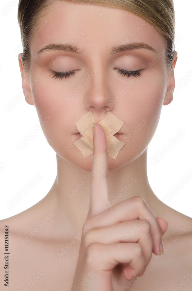face of young woman with plaster and finger face of young woman with plaster and finger