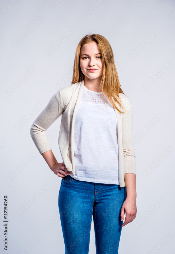 Girl in jeans and beige cardigan, woman, studio shot Girl in jeans and beige cardigan, woman, studio shot