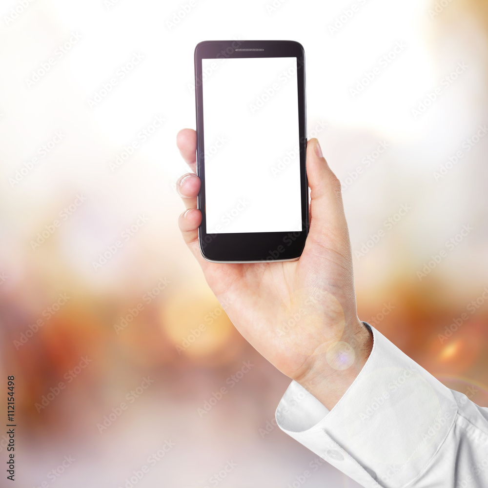 Hand shows mobile smart phone, blurred background Hand shows mobile smart phone, blurred background