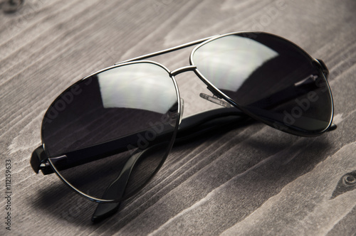 Sunglasses black on wooden background
