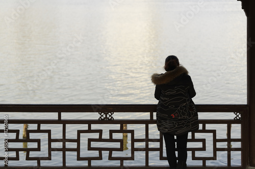 Sihlouette of woman looking over water