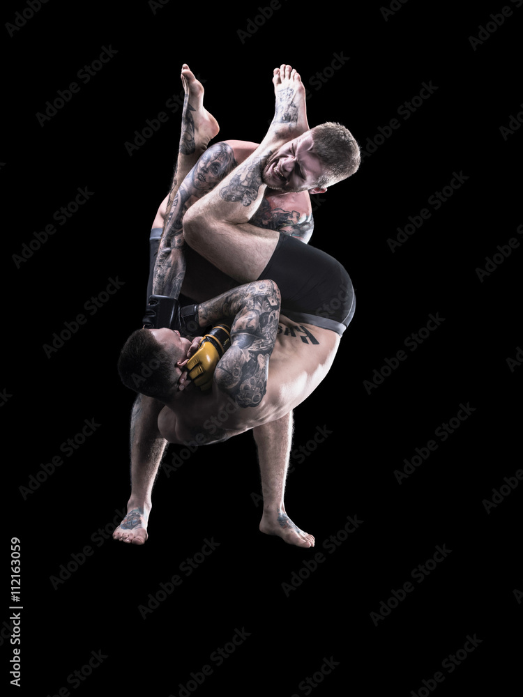 Mixed martial artists fighting on black background Mixed martial artists fighting on black background