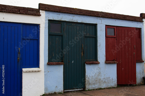 Old disused beach huts on the seafront in Bude photo