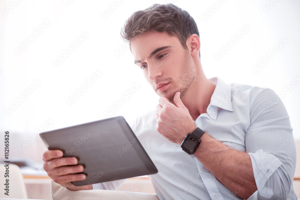 Thoughtful handsome man using tablet Thoughtful handsome man using tablet