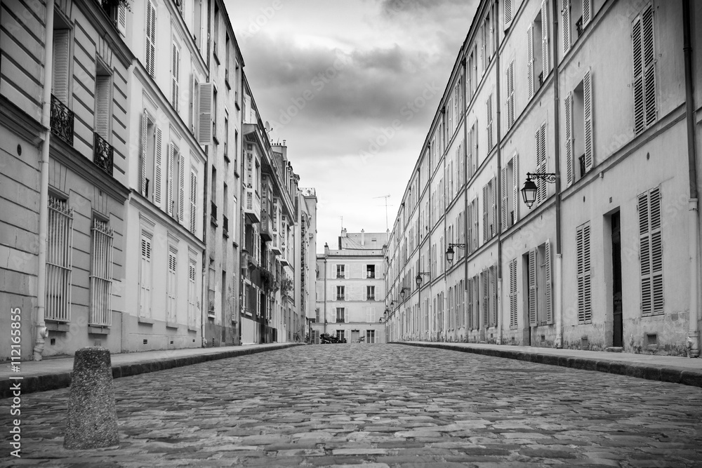 Naklejka premium Deserted street in Paris on a cloudy day