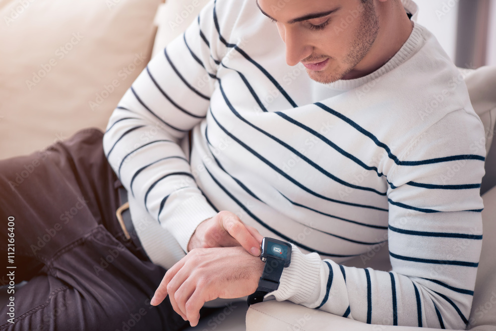 Pleasant man using smartwatch Pleasant man using smartwatch