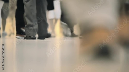 Legs, anonymous group of people walking, crowded interior, Grand Central Station in NYC