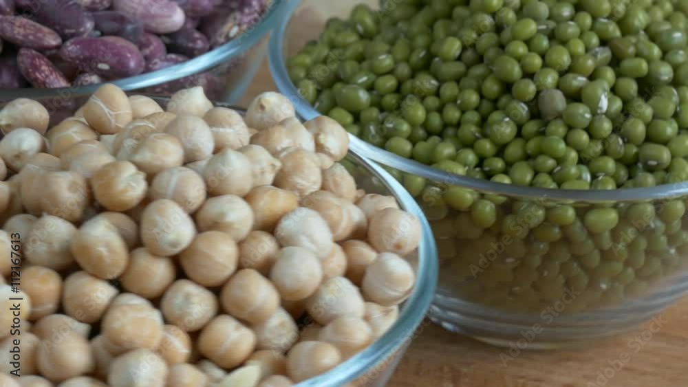 Glass bowls of chickpea, mung beans and red beans in rotation. Close up Glass bowls of chickpea, mung beans and red beans in rotation. Close up
