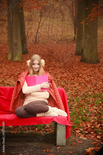 Blonde girl with red book.