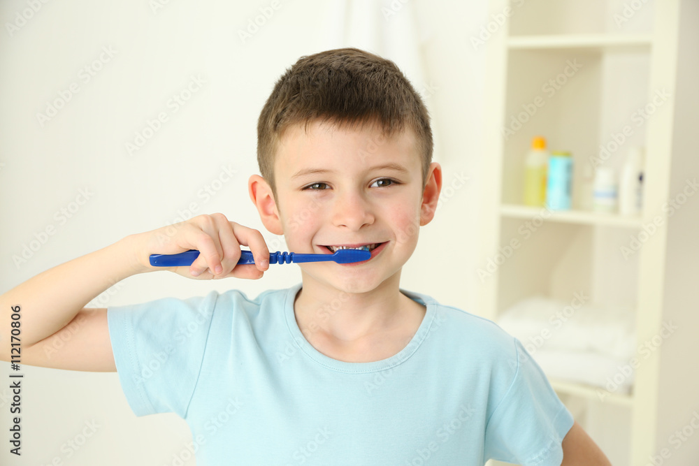 Smiling little boy brushing teeth, close up Smiling little boy brushing teeth, close up