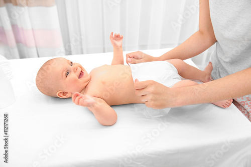 Mother changing diaper to l...