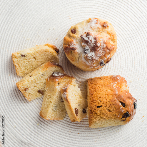 Homemade sliced carrot muffin with empty space on white fabric background. Copyspace top view