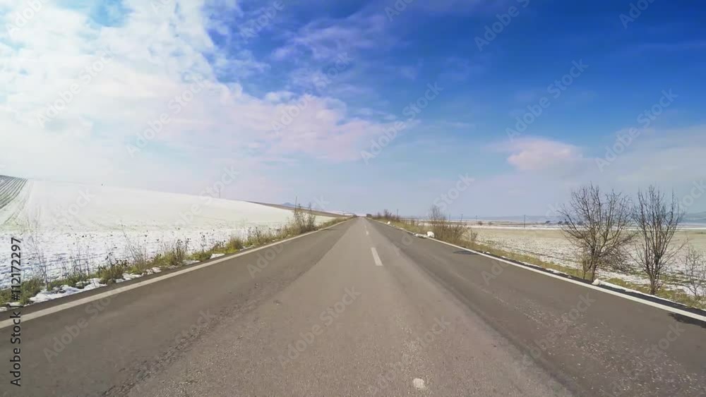 Winter agricultural countryside scenery POV car vehicle drive snow open road fields valley clouds blue sky Winter agricultural countryside scenery POV car vehicle drive snow open road fields valley clouds blue sky