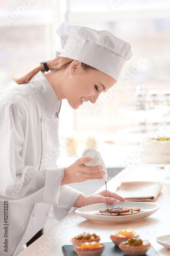 Female chef working at kitchen