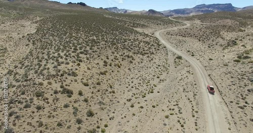 Aerial drone scene of dry, desert mointainous landscape. High perspective of dry panorama with dirt road. Starts from lower altitud to a higer visual.  Patagonia, argentina, Chubut, Piedra Parada. 
 photo