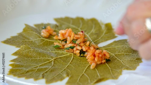 Prepearing turkish Dolma - vine leaves stuffed with ground beef and rice 