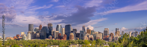 View of the Calgary skyline in the evening with parkland in the foreground.