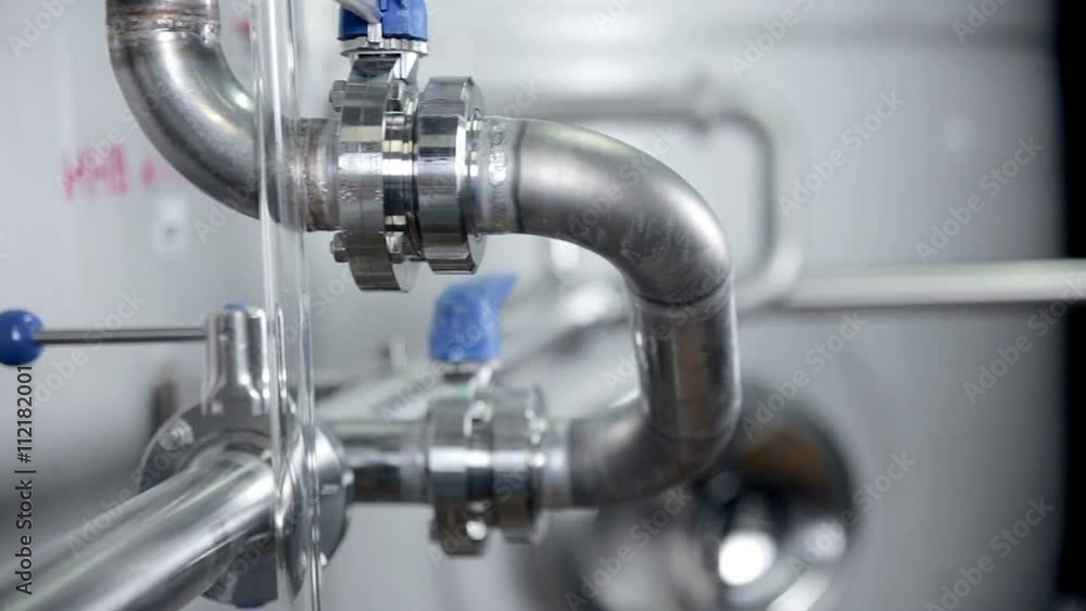Pipelines with valves at modern plant, factory indoor. Pipelines with valves at modern plant, factory indoor.