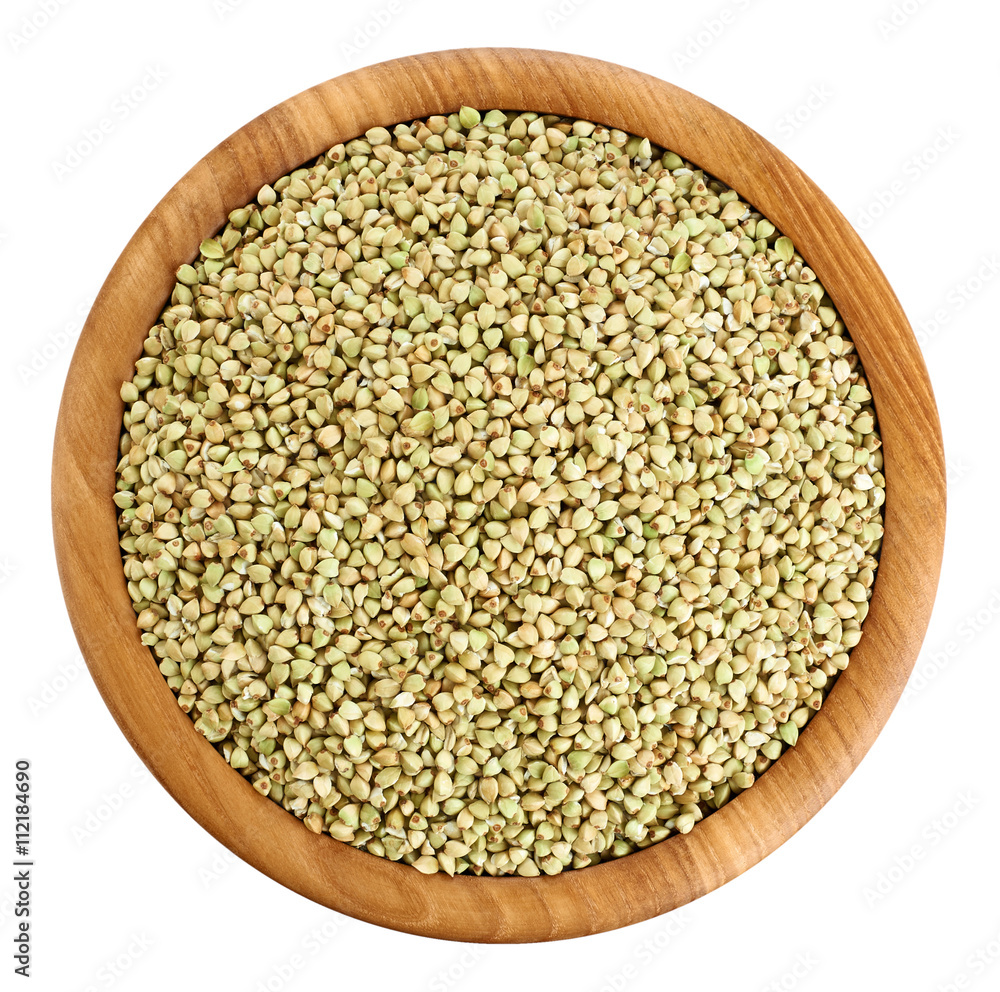 Wooden bowl with green buckwheat isolated on white background. Wooden bowl with green buckwheat isolated on white background.