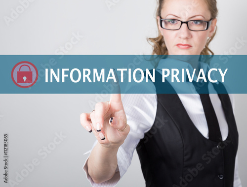 information privacy written on a virtual screen. Internet technologies in business and tourism. woman in business suit and tie, presses a finger on a virtual screen photo