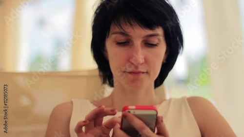 Young woman with smartphone in cafe