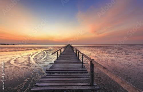 Fototapeta Naklejka Na Ścianę i Meble -  Abandon Jetty on beach with colorful sunrise . Teluk Tempoyak, Penang, malaysia