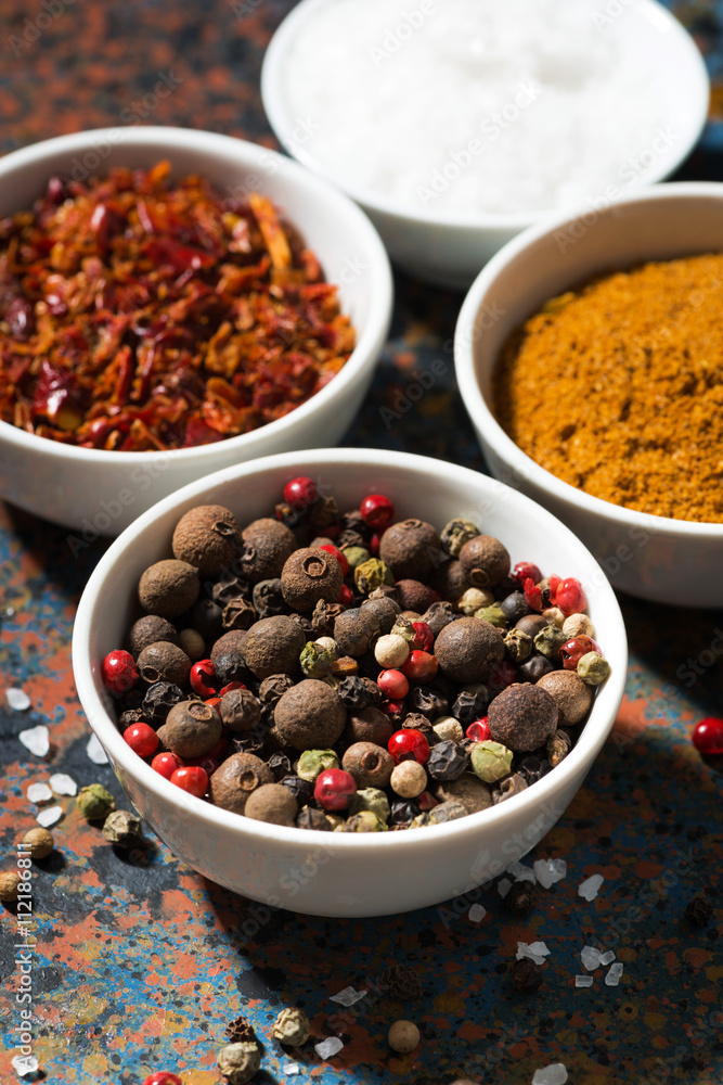 assortment of pepper, different spices and sea salt in bowl assortment of pepper, different spices and sea salt in bowl
