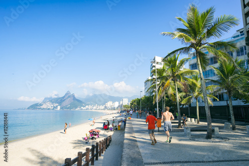 Early morning view of an empty Ipanema Beach from the shadows of Apoador in Rio de Janeiro, Brazil