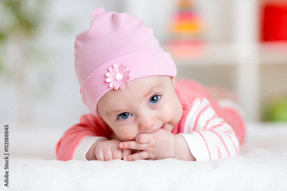 Baby teething sucks fingers. Infant kid lying in nursery Baby teething sucks fingers. Infant kid lying in nursery