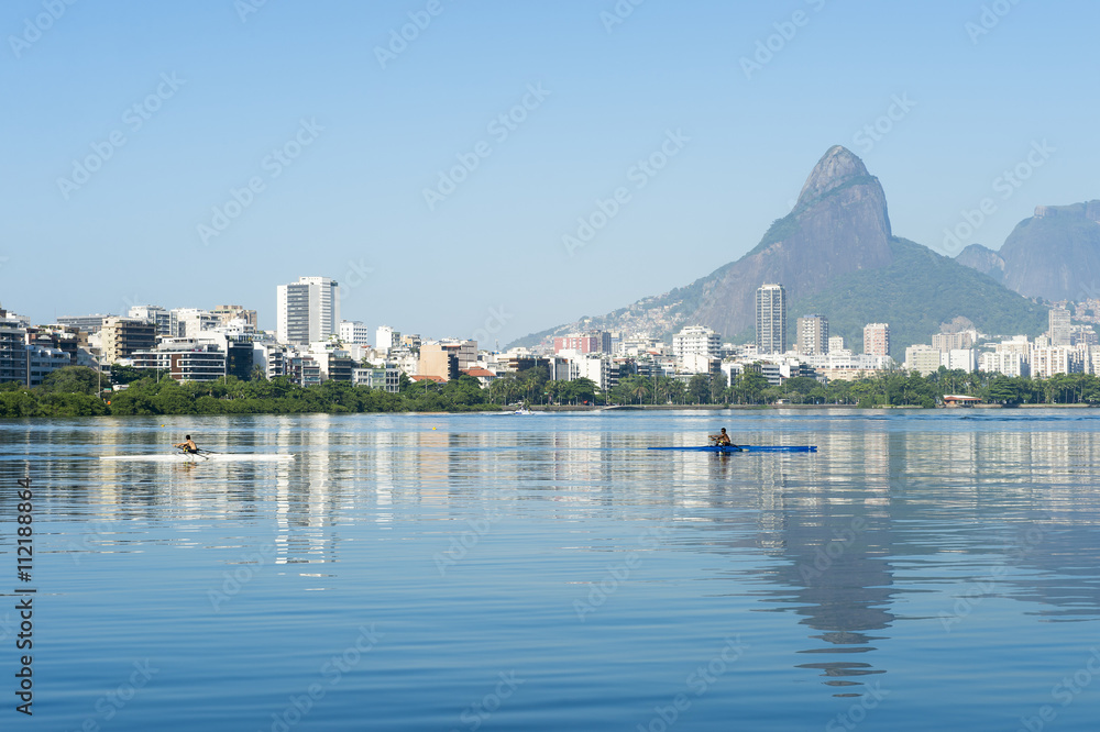 Scenic skyline morning view of Lagoa Rodrigo de Freitas lagoon in Rio de Janeiro Brazil with Ipanema and Leblon reflecting on the calm horizon 