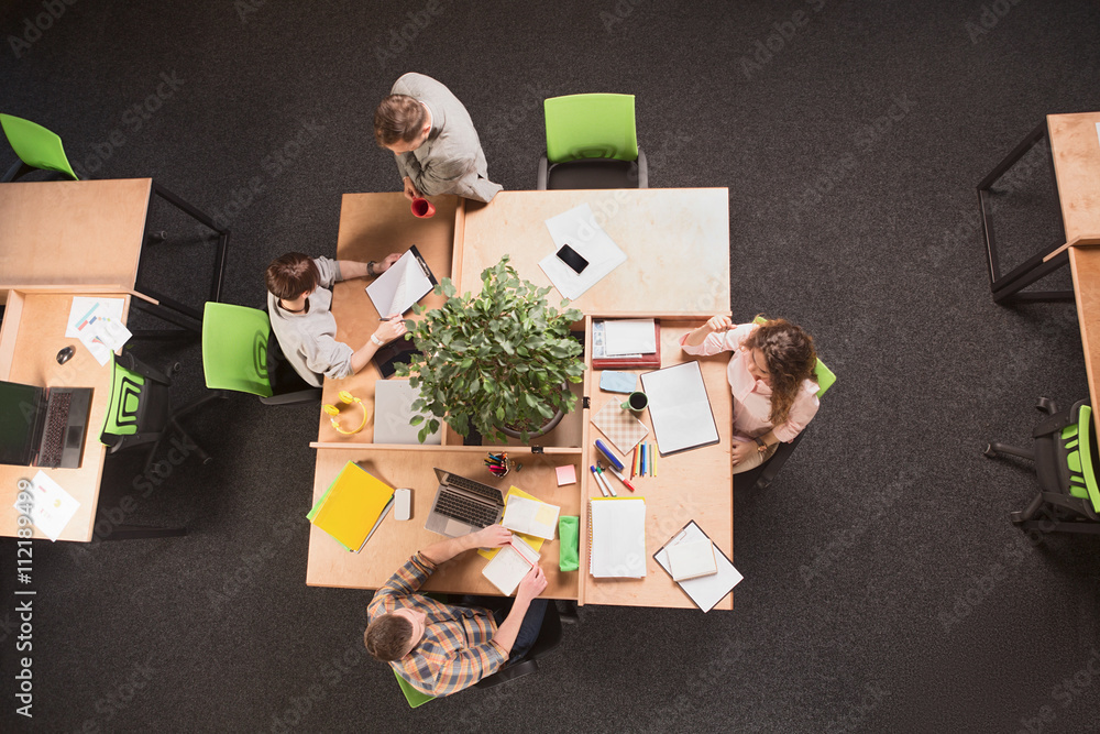Top view of business people having round tablein office. People working and discussion certain business projects. Business and freelance concepts. Top view of business people having round tablein office. People working and discussion certain business projects. Business and freelance concepts.