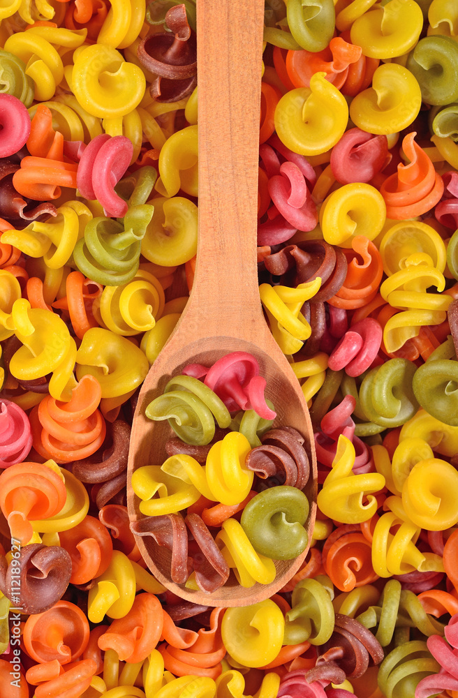 Colored italian pasta in a spoon