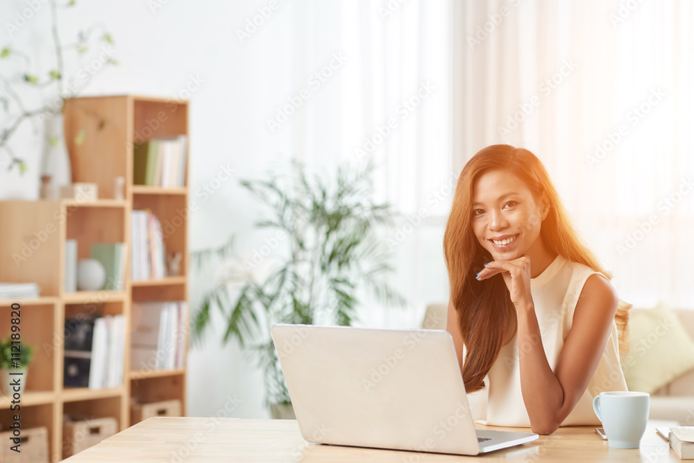 Portrait of lovely young business lady working on laptop in office Portrait of lovely young business lady working on laptop in office