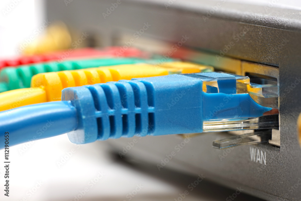 ethernet cable plugged into network router ethernet cable plugged into network router