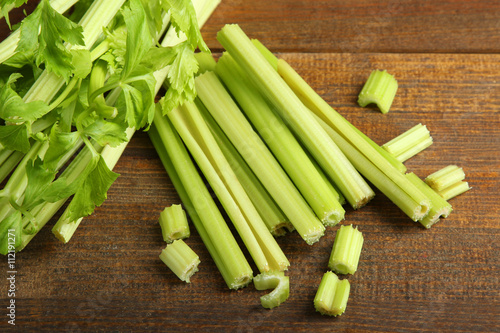 Fresh green celery on wooden brown background