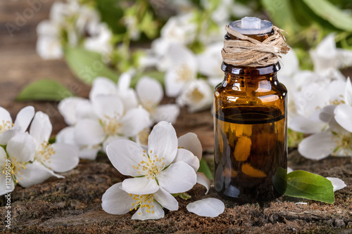 Essential oil made from jasmine on a rustic table