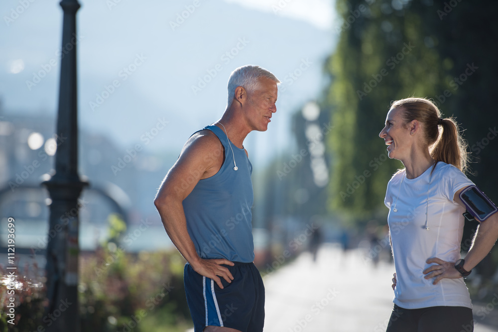 jogging couple planning running route and setting music jogging couple planning running route and setting music