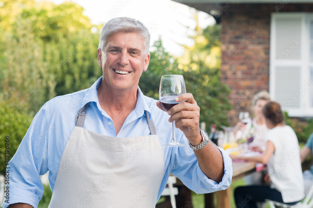 Senior man raising toast Senior man raising toast