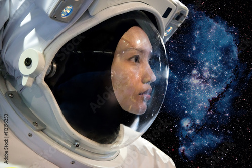 Astronaut woman on space mission with stars on the background