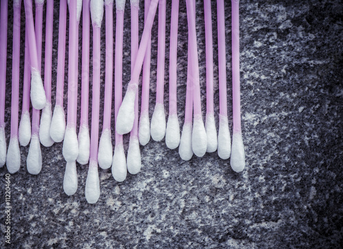 Cotton swaps in close up. Pink sanitary qtips suitable as makeup accessory. Soft cotton buds for skin care or cleaning. Symbol of hygiene, beauty care and bathroom items. photo