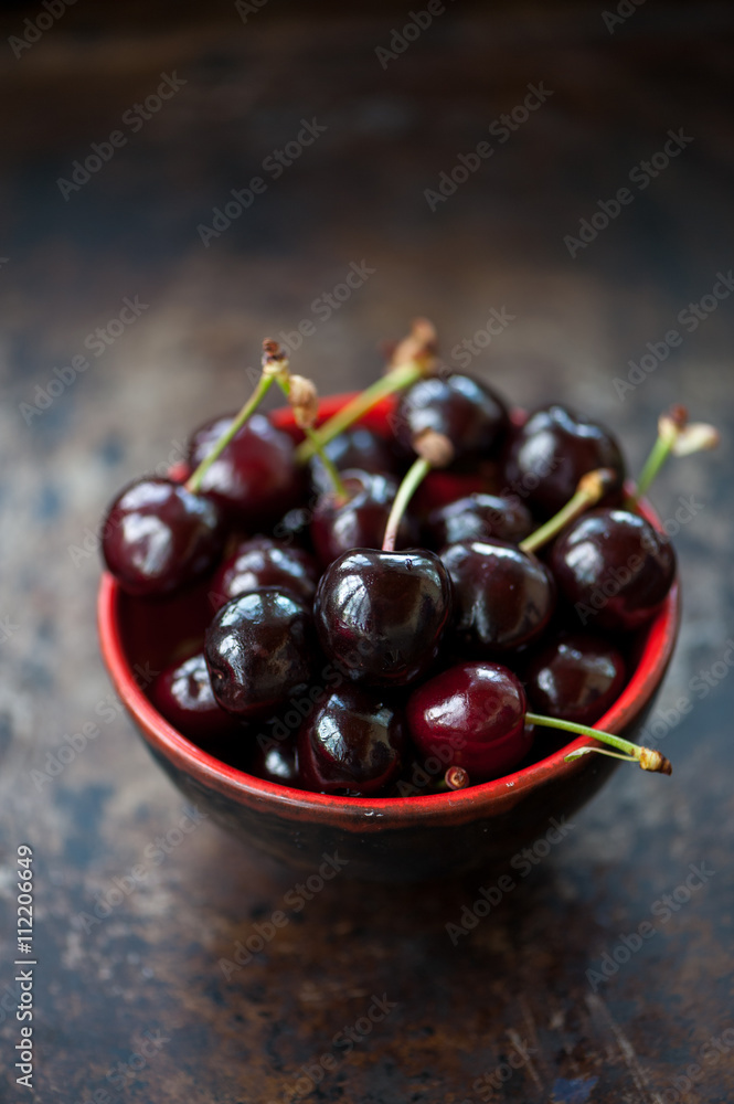 Cherries in a red bowl Cherries in a red bowl