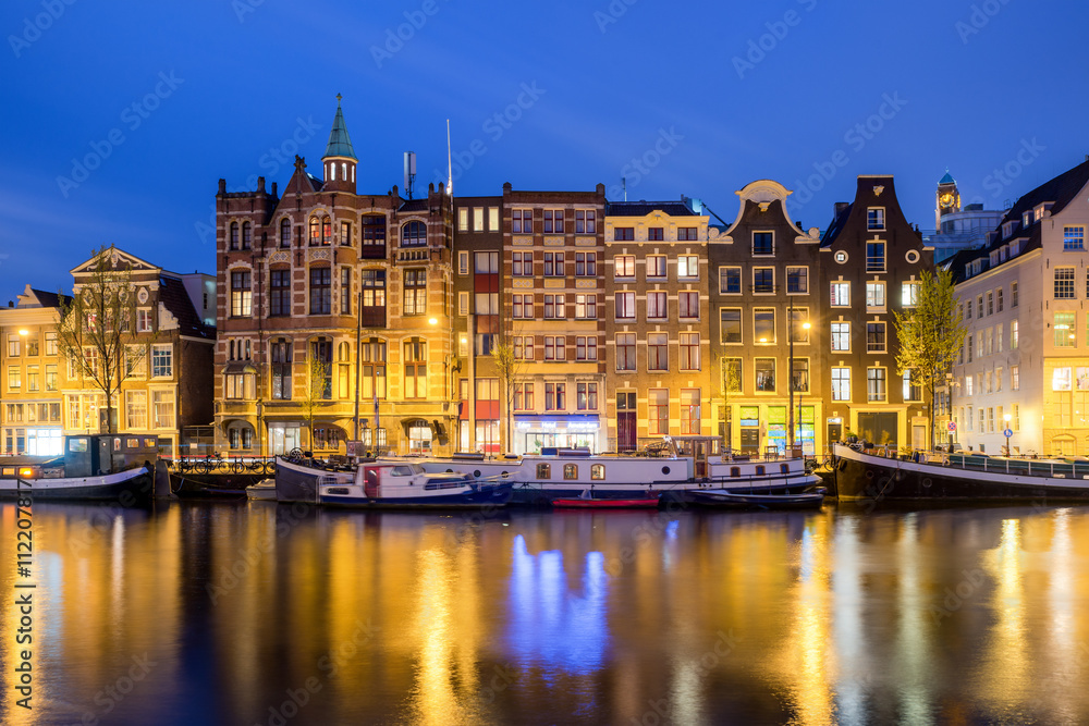 Traditional Dutch houses at night in Amsterdam, Netherlands.