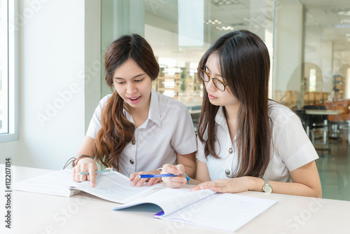 Two Asian students studying together at university © ake1150