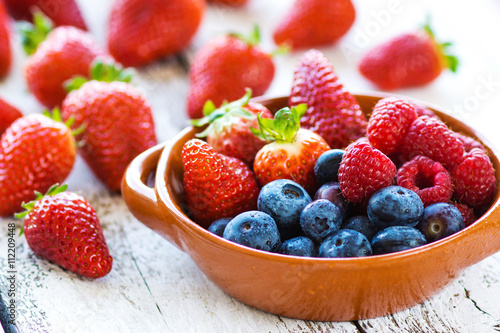 Delicious berries on a wooden background